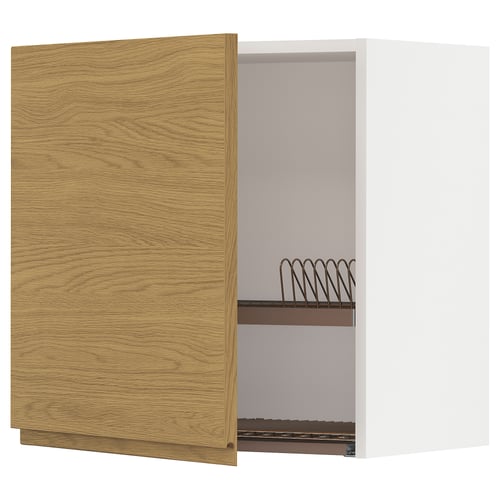 A wooden kitchen cabinet with an open door, revealing metal racks inside.