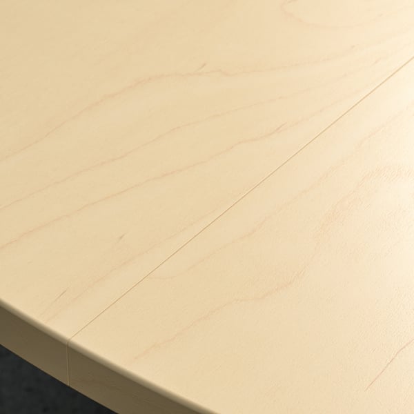 Smooth, light-colored round wooden conference table.
