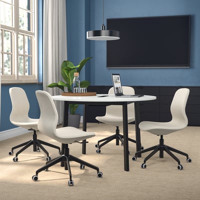 MITTZON meeting table with swivel chairs, fits under tv, near windows and plant.