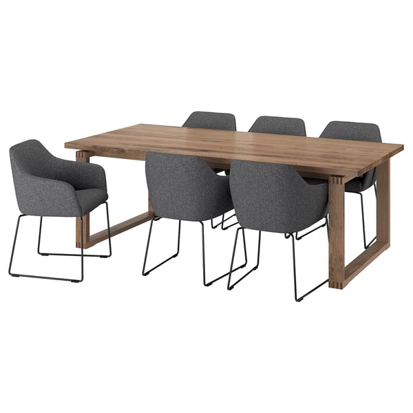 A mörlig dining set with oak table and 4 grey chairs with metal legs.