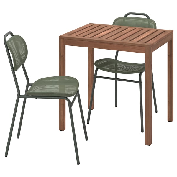 Set of wooden table with two green mesh chairs.