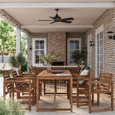 Large wooden patio set with table and chairs. Bright brown colour. Handles several people. Under brick house porch.