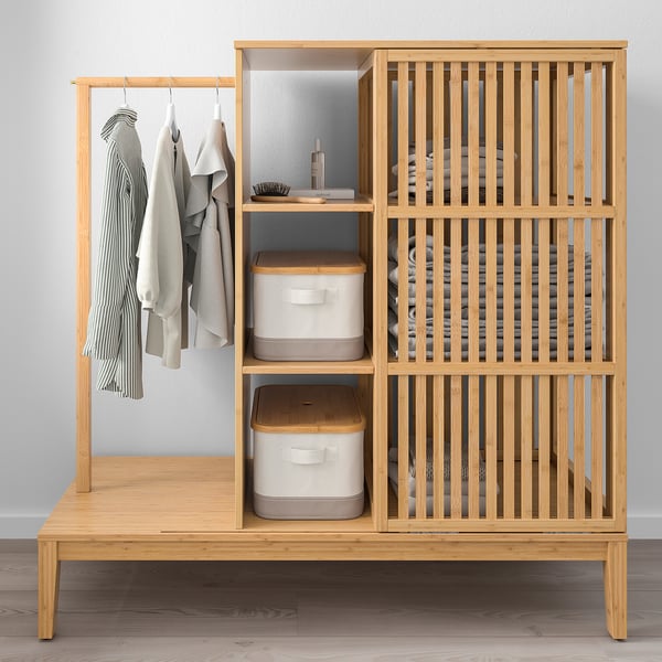 Modern wooden wardrobe with clothes rail, shelves, and storage bins, ideal for organising clothes and accessories.