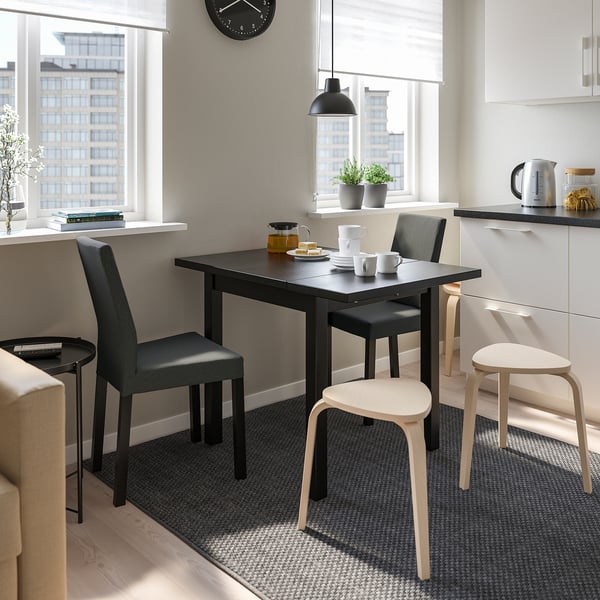 Modern dining setup with foldable NORDVIKEN table for small spaces, enhanced by bright window views.