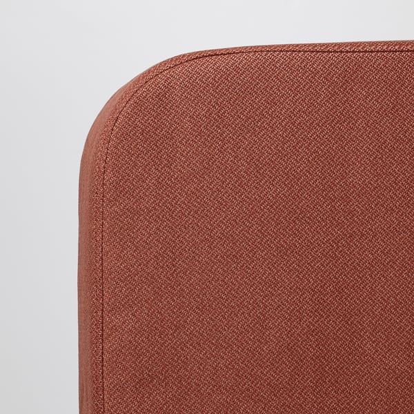 Close-up of a red, textured sofa backrest, showing robust stitching and high-quality fabric.