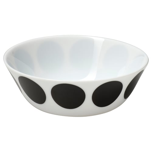 A white ceramic bowl with black circular dots along the sides.