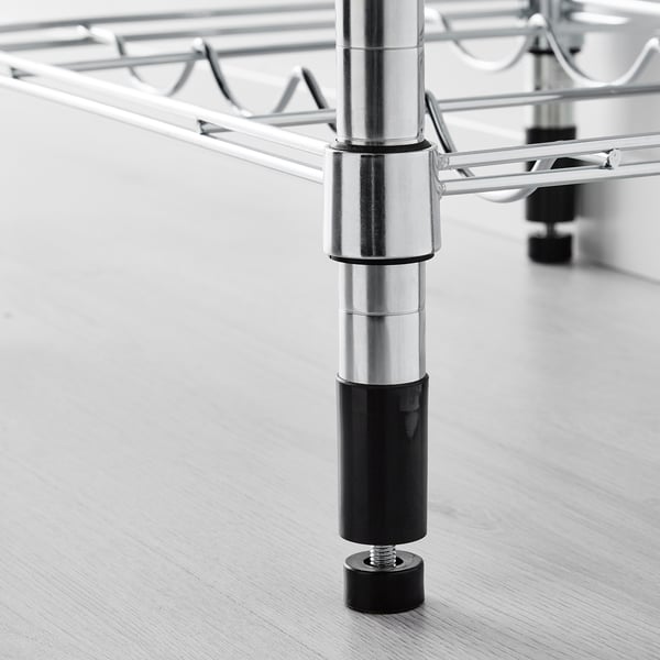 Close-up of adjustable, sturdy metal shelf leg with black foot for stability.