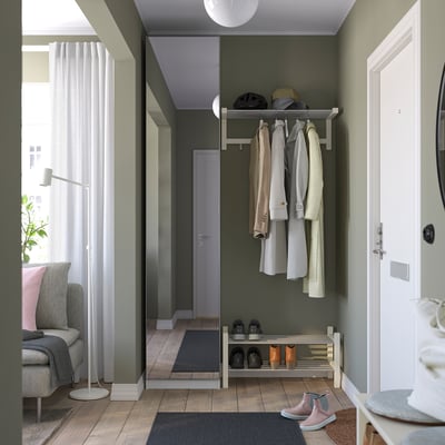 Modern entryway: shoe & coat rack, chair, lamp, window.