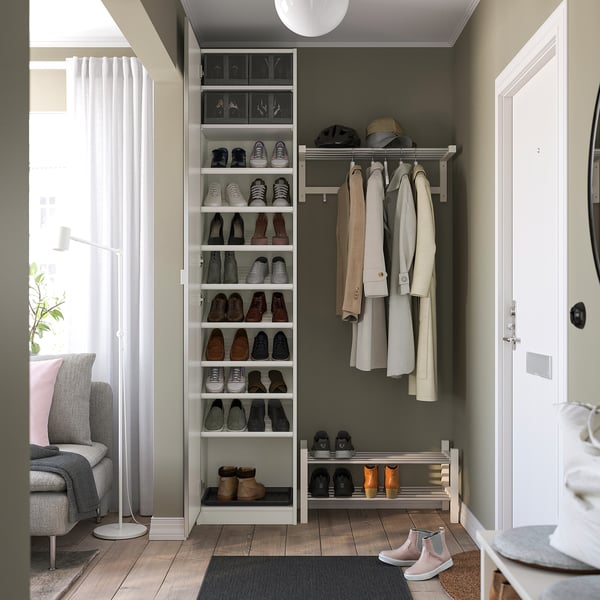 Well-organized entryway with shoe storage shelves and coat rack, featuring a modern design and efficient use of space.