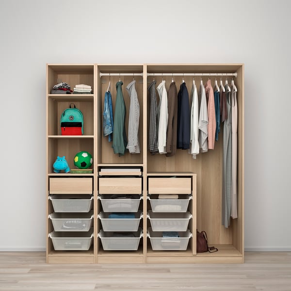 A kids wardrobe with a hanging rod for clothes, shelves for toys, and drawers with mesh baskets for folded clothes.