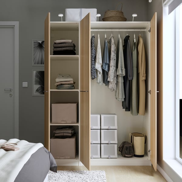 Bedroom closet with mirror doors showing clothes, folded garments, and storage boxes. Hangs about 40 shirts.