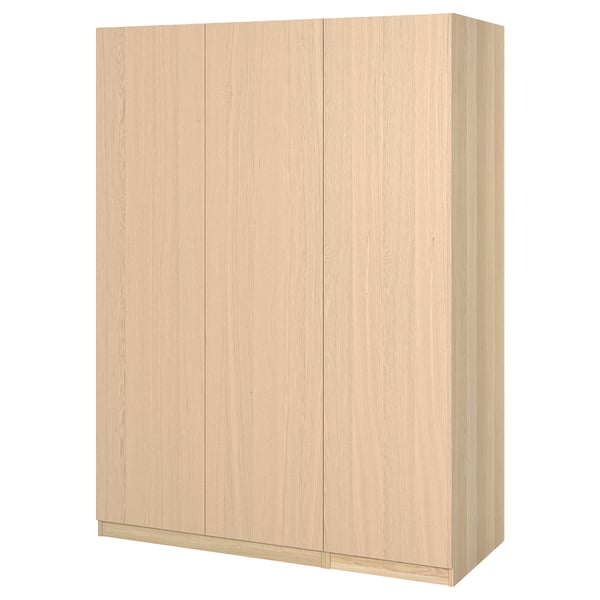 Light coloured wooden wardrobe, rectangular shape, smooth finish, with four flat panels and two doors.
