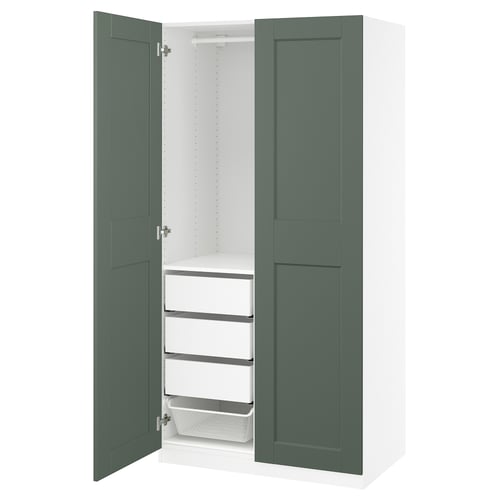 Open green and white wardrobe PAX showcasing shelves and baskets.