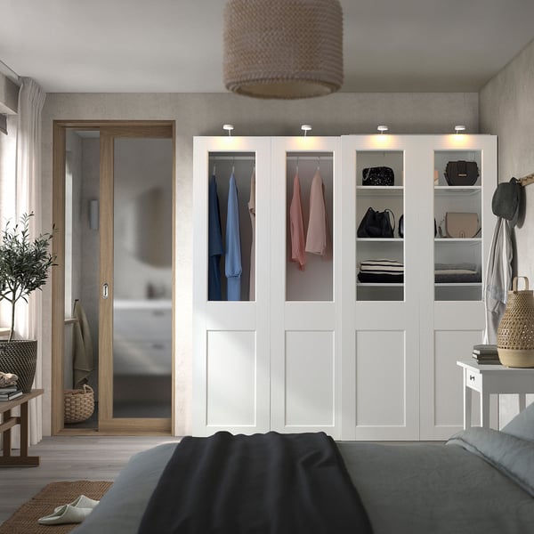 Modern bedroom with PAX wardrobe, bed, and bags.