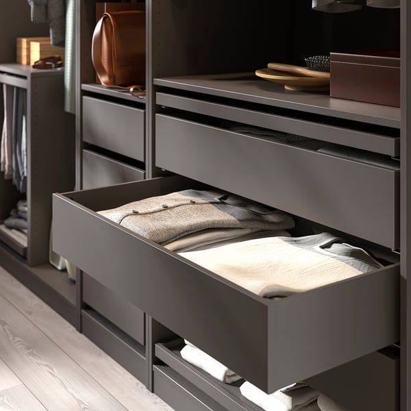 Modern closet with drawers; one open, showing folded clothes. Adjustable feet and soft-close hinges.