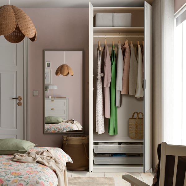 Organised bedroom with wardrobe and mirror.