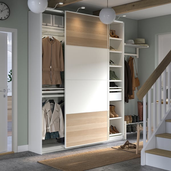 Modern wardrobe named PAX, white & light wood, sliding doors, organising shelves & drawers, stairs nearby.