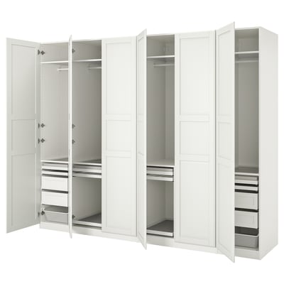 White PAX wardrobe with open doors showing compartments, shelves, and drawers. Modern, organised design.