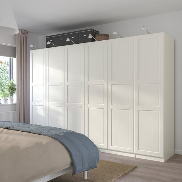 Modern bedroom with large white PAX wardrobe, extensive storage.