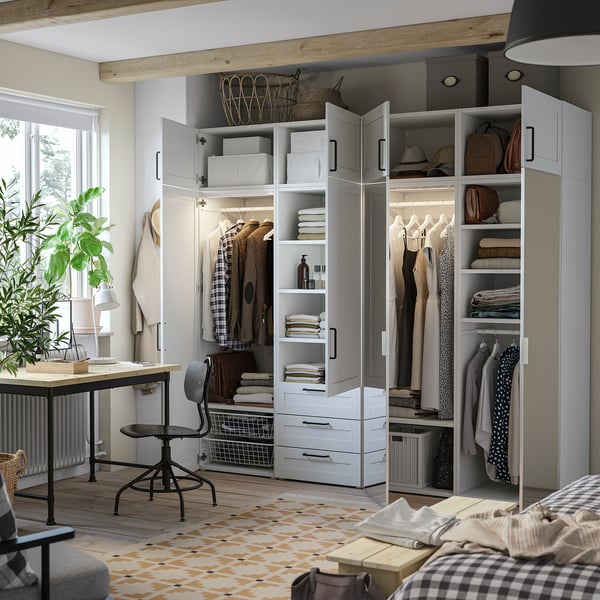 Organised closet with open/closed storage, clothes, bags, drawers, shelves, light wood, white finishes.