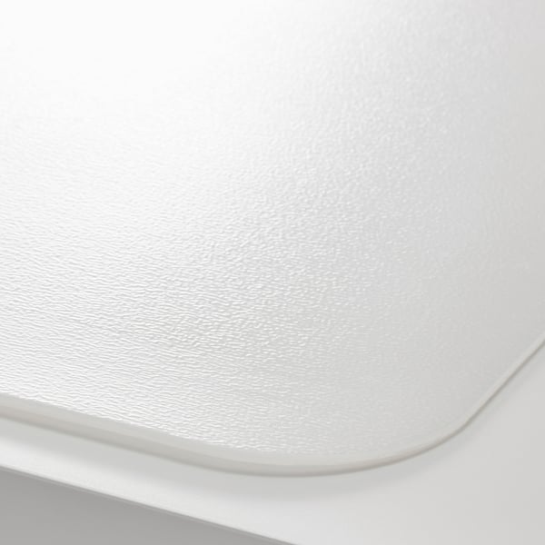 Close-up of a white desk pads smooth, protective surface.