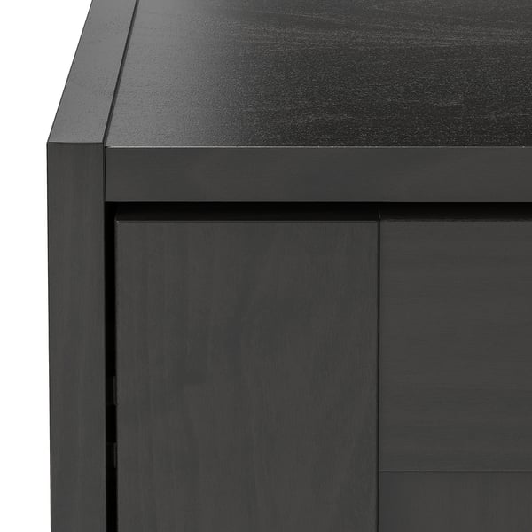 Black wooden cabinet with sleek design, smooth surface, and clean edges. Wardrobe offers modern storage solution.