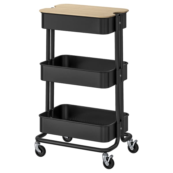 An ikea RÅSKOG cart in black. Its a 3-tier rolling utility cart made of steel with a wooden top.
