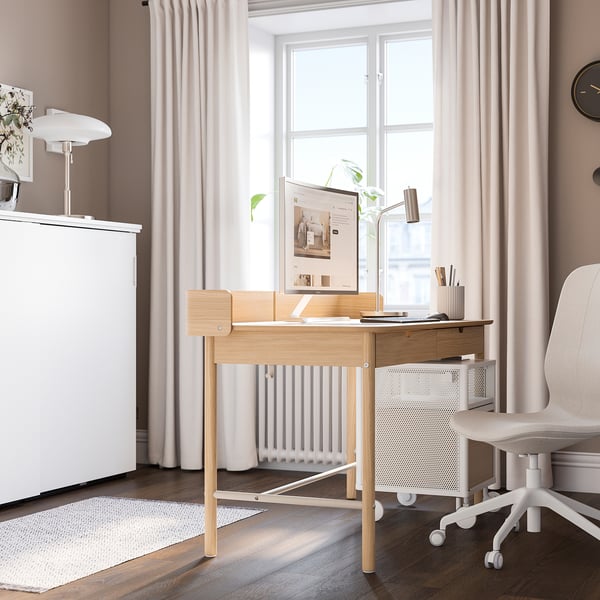 Minimalist home office with RIDSPÖ desk, chair, fridge, and decor.