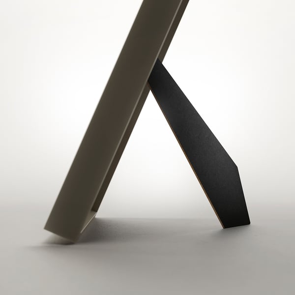 Metal picture frame displayed as a stand. Modern design, can hang or stand vertically or horizontally.