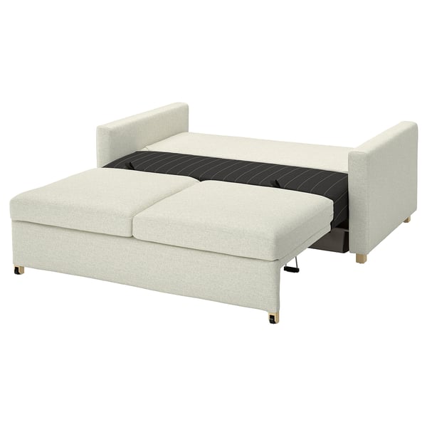 An off-white saltsjbaden convertible sofa-bed with light wooden legs, designed for comfort and space efficiency.