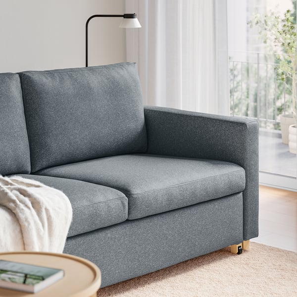 Modern grey sofa-bed, featuring clean lines, supportive cushions, and easy-access design, perfect for small spaces with quick convertibility to a bed.
