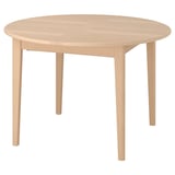 A SKANSNÄS light wood dining table with a round shape and natural finish. It has four tapered legs and an extendable centre for added seating.