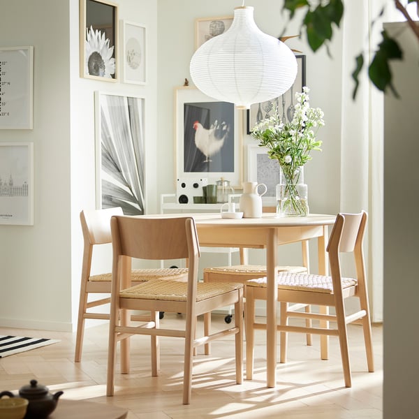 Minimalist dining area with SKANSNÄS table, chairs, butterfly leaf, and large lamp.