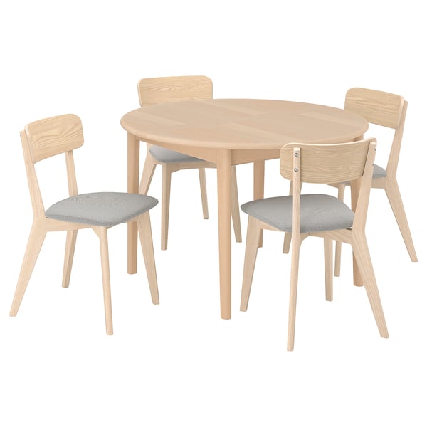 Round wooden dining table with 4 light grey cushioned chairs.