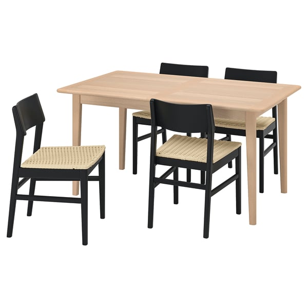 Displays a SKANSNÄS dining set. It includes a light brown wooden table and four matching chairs with black frames and woven seats.