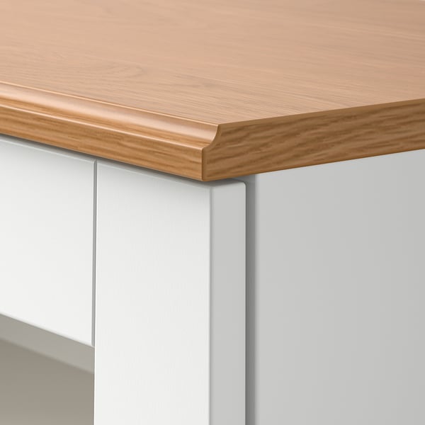 Close-up of SKRUVBY furniture edge: light wood top, smooth finish, sleek design.