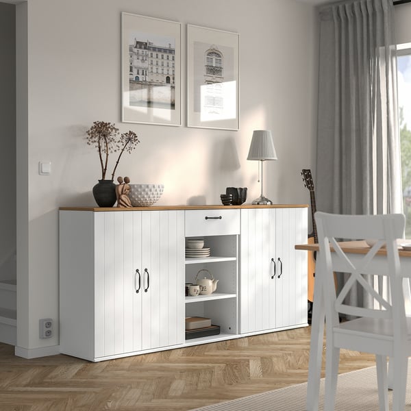 SKRUVBY sideboard with closed & open shelves, decorated, under pictures.