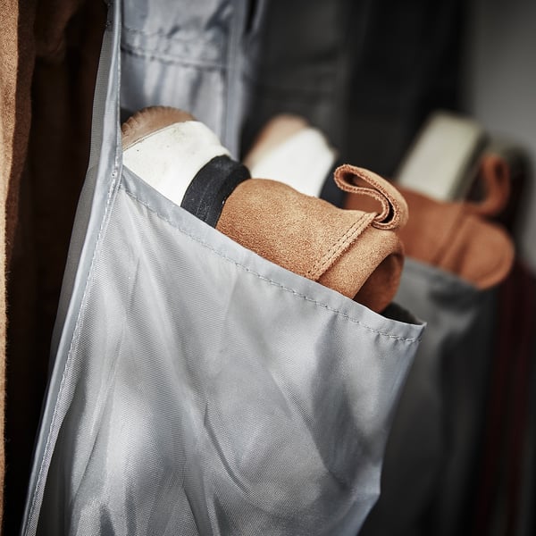 A grey SKUBB shoe organiser with multiple pockets, holding shoes and accessories.