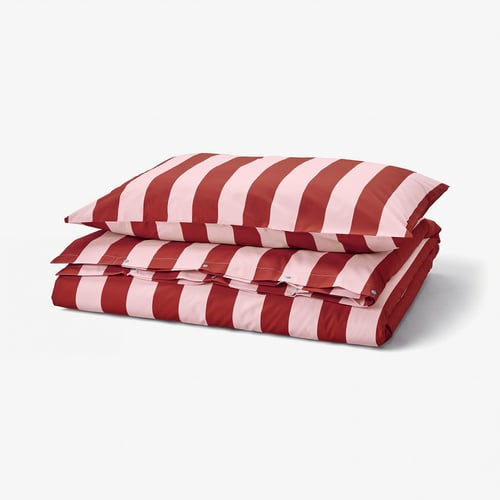 Red and white striped duvet set, folded neatly. Thick, horizontal stripes; made from durable cotton and lyocell blend.
