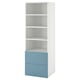 A SMÅSTAD bookcase in white with blue drawers. Its tall, narrow, and has four open shelves with two drawers at the bottom for additional storage.