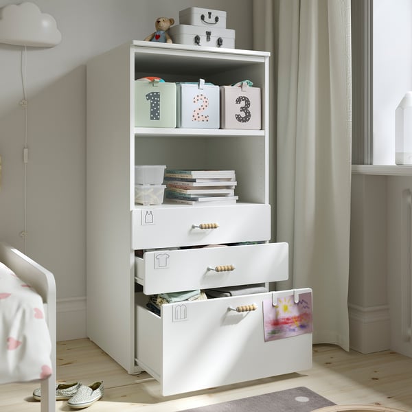 Childrens storage unit with open shelves for books and toys, and multiple drawers for extra storage.