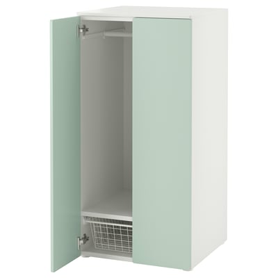 An a tall, light green SMÅSTAD cabinet with one door open revealing a shelf and hanging rail.