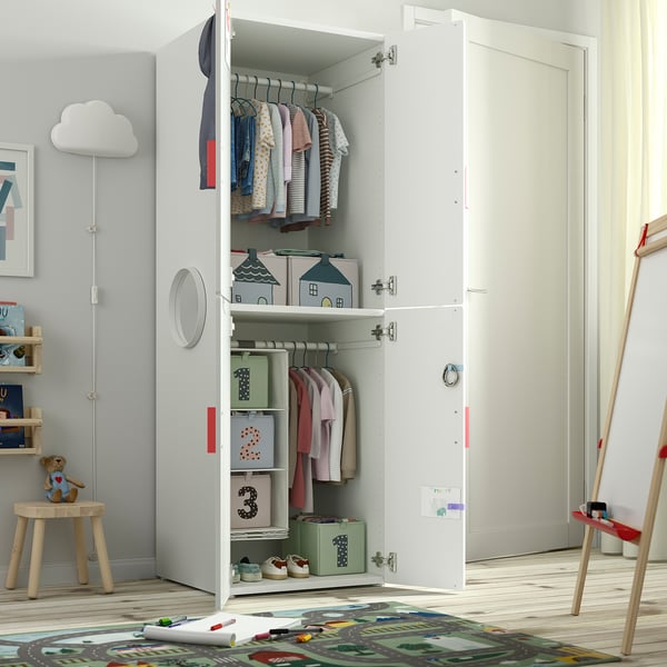 A white SMÅSTAD wardrobe with open doors, showing clothes and storage, ideal for kids rooms.