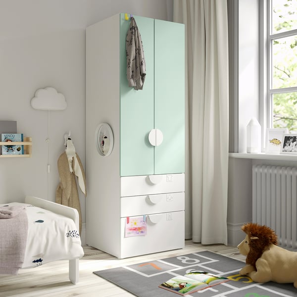 Green SMÅSTAD wardrobe with toy on play mat.