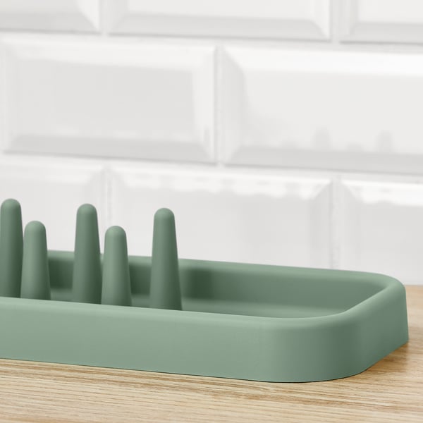 Dish drainer with adjustable compartments on wood. This retains the key details while fitting within the character limit.