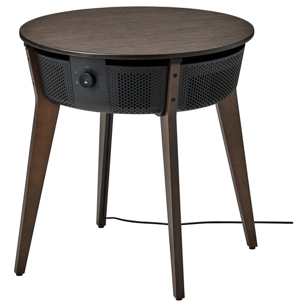 A brown STARKVIND air purifier table with a wooden top, metallic body, four angled legs, and control dial on the front.