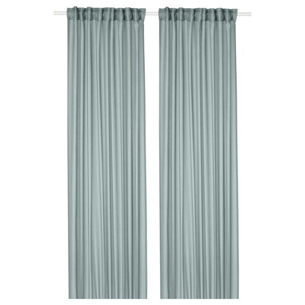 Stenfro turquoise sheer curtains, made from recycled polyester, hang straight and soften light, giving a coastal vibe.