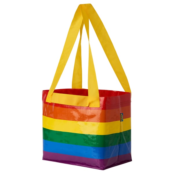 Rainbow-colored reusable bag with yellow handles, square base, and sturdy design.