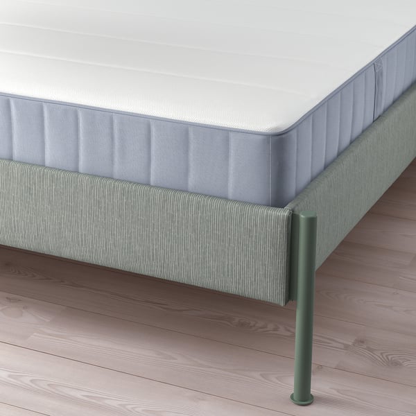 A modern bed frame with adjustable sides, featuring a soft headboard and sleek metal legs.