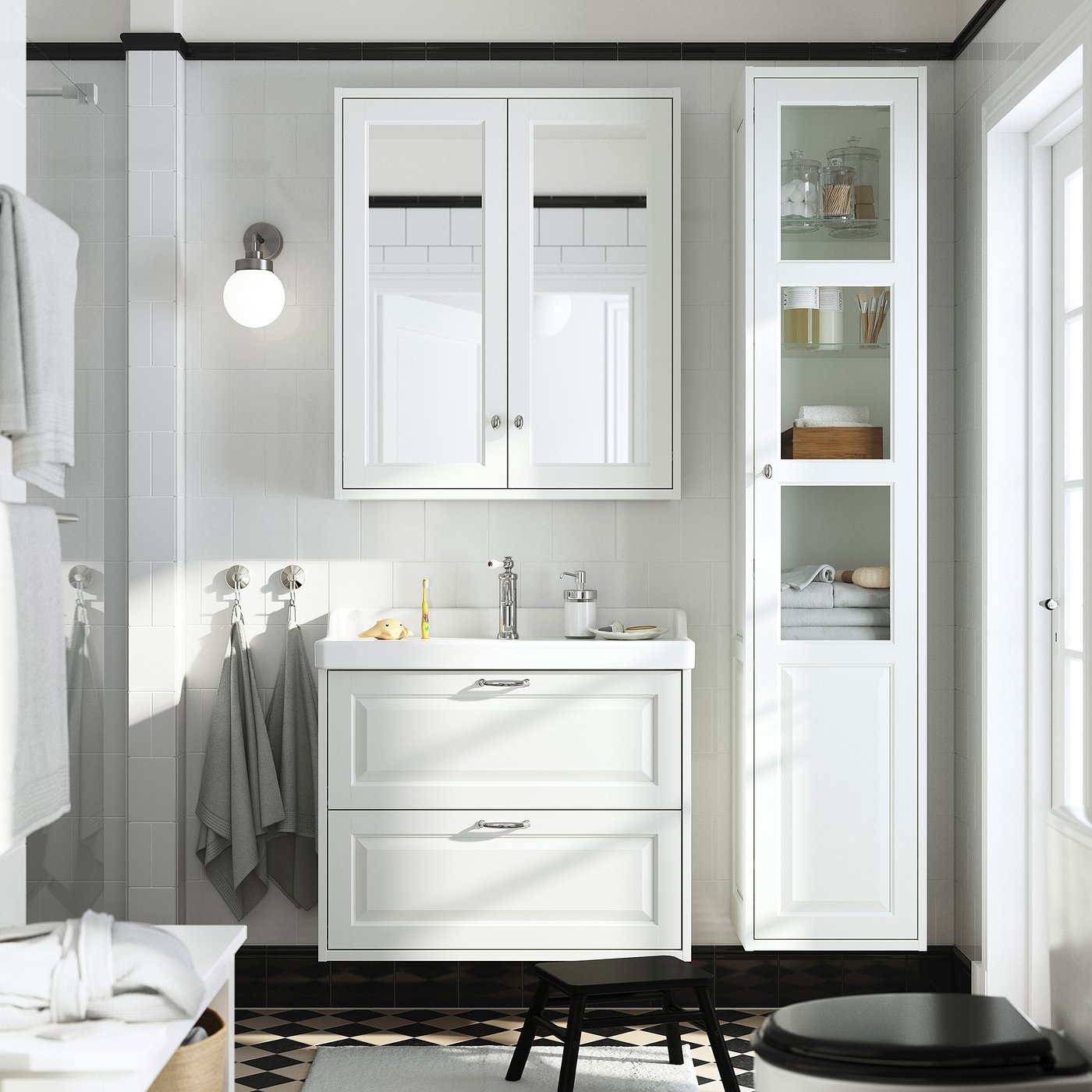 Modern bathroom with white TÄNNFORSEN vanity, large mirror, draws & open shelves. Toilet & towels nearby.